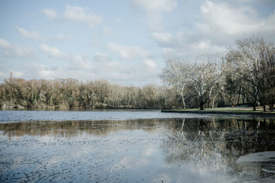 Scenic view of lake against cloudy sky