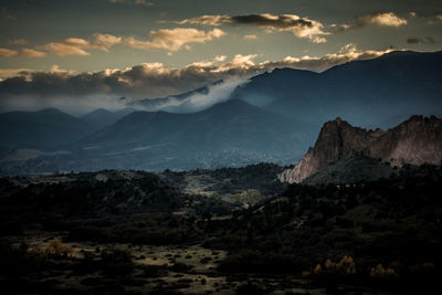 Scenic view of mountains against cloudy sky