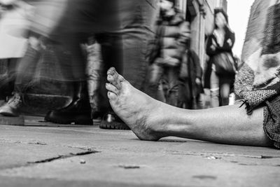 Low section of people walking on street