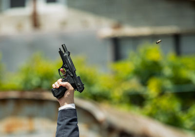 Close-up of man holding gun