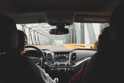 Rear view of man driving car