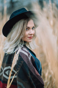 Portrait of smiling young woman wearing hat