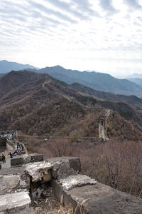 Scenic view of mountains against cloudy sky