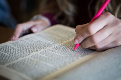 Midsection of person writing on book