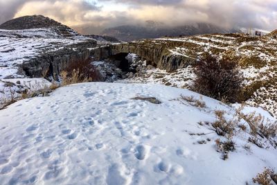 Scenic view of snow covered mountains against sky