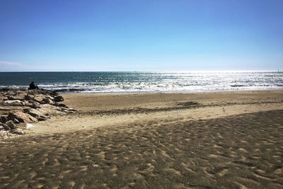 Scenic view of beach against clear sky