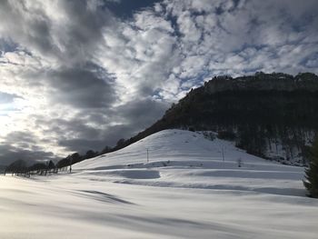 Scenic view of snow covered landscape against sky