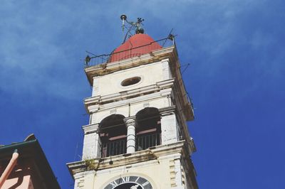 Low angle view of bell tower against blue sky