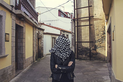 Rear view of woman standing on street