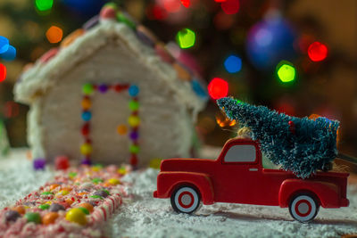 Close-up of toy car on christmas tree at night