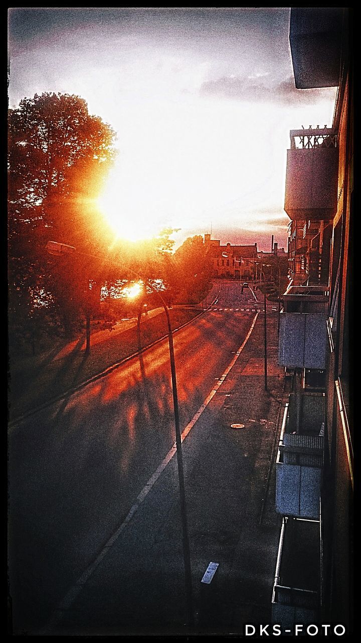 CITY STREET AGAINST SKY DURING SUNSET