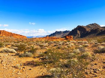 Scenic view of rocky mountains against blue sky