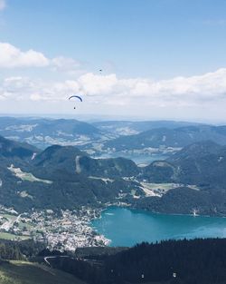 Aerial view of sea and mountains against sky