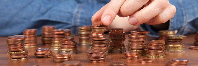 Close-up of hand holding objects on table