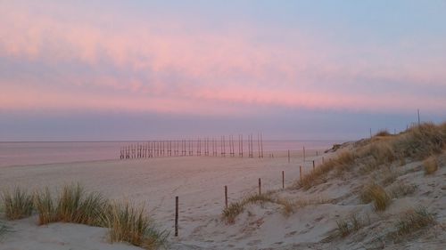 Scenic view of beach against sky during sunset