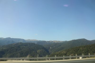 Scenic view of mountains against clear blue sky