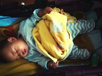 Close-up of baby boy sleeping in bed