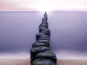 View of rock in sea against sky