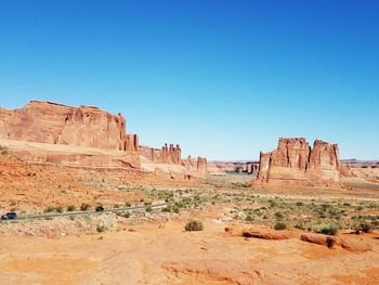 Rock formations in desert against clear blue sky