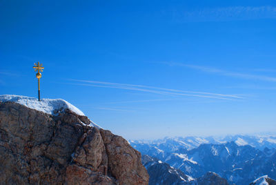 Scenic view of snowcapped mountains against blue sky