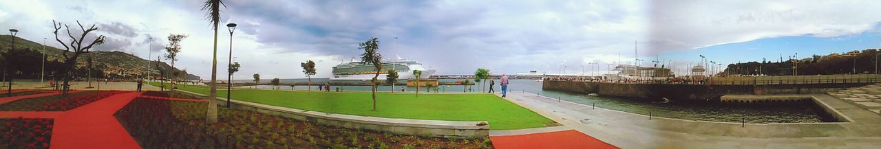 sky, cloud - sky, building exterior, built structure, architecture, cloudy, cloud, panoramic, incidental people, religion, outdoors, day, house, roof, place of worship, tree, spirituality, city, no people, weather