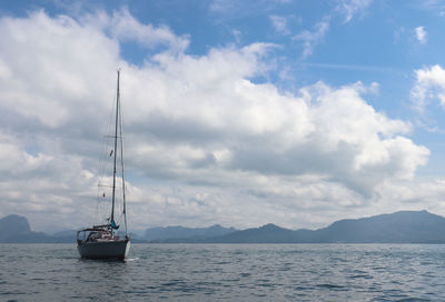 Boat sailing on sea against sky