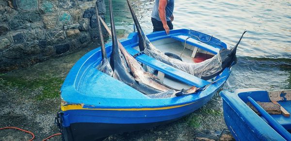 Fisherman's boat on the seashore with swordfish