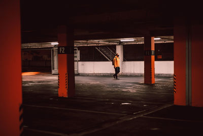 Rear view of man standing by building