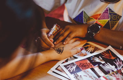 High angle view of woman holding hands on table