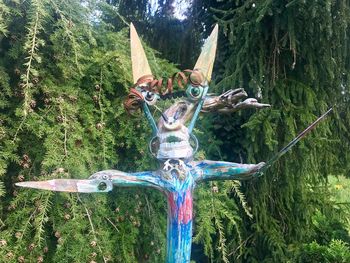 Close-up of sculpture against trees in forest