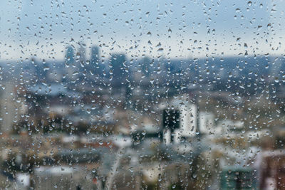 Full frame shot of wet glass window in rainy season