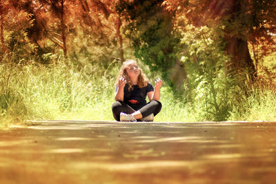 Full length of woman sitting in park