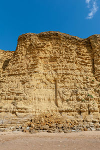 Low angle view of rock formations against sky