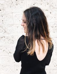 Beautiful woman standing against wall