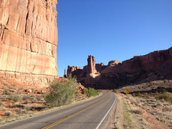 Road amidst rocky mountains at arches national park