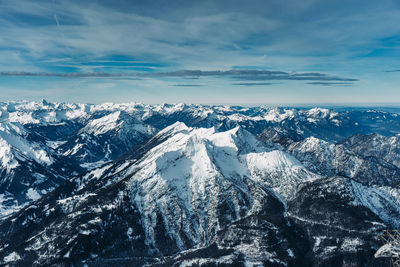 Aerial view of snowcapped mountains against sky