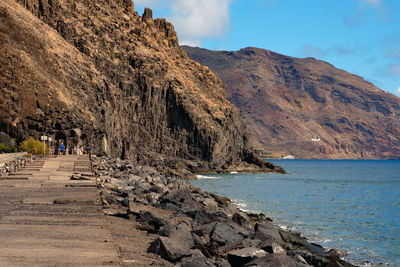 Scenic view of sea and mountains against sky