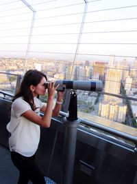 Woman looking through binoculars