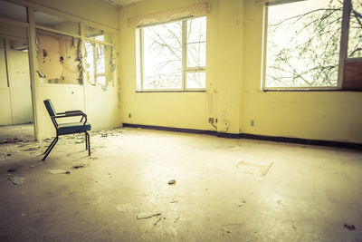 Empty chair in abandoned room