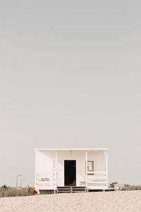 House on beach against clear sky