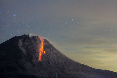 Lava running dowm sinabung volcano, seen from the village tiga pancur, karo, north sumatra