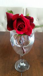 Close-up of red roses in vase on table