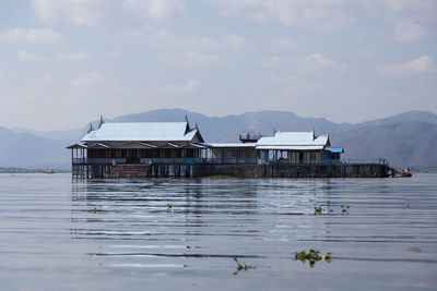 Pretty stilt buildings with pale blue roofs on inle lake, myanmar