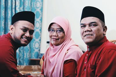 Portrait of siblings wearing traditional clothing at home