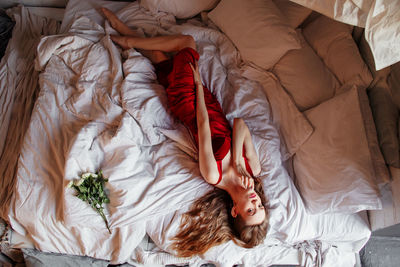 High angle view of woman lying on bed