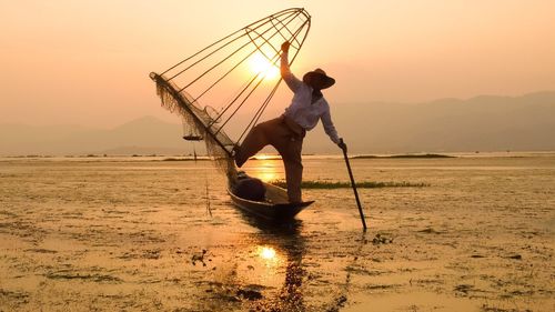 Silhouette of woman at sunset