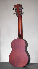 Close-up of guitar on table against white background