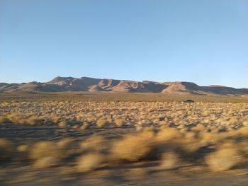 Scenic view of arid landscape against clear sky