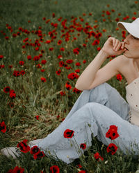 Young woman sitting on field