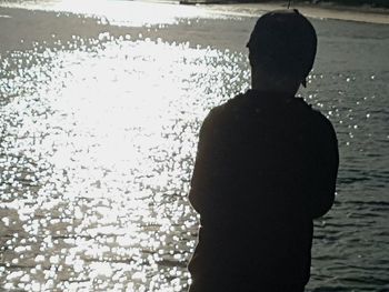 Silhouette of man in water